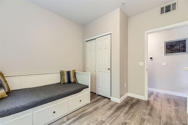 12818 Ironstone Way Unit 101, Parker, CO 80134 - unfurnished bedroom with light wood-style floors, a closet, and baseboards