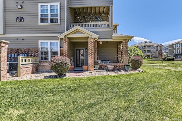 12818 Ironstone Way Unit 101, Parker, CO 80134 - property entrance featuring brick siding, a yard, and a balcony