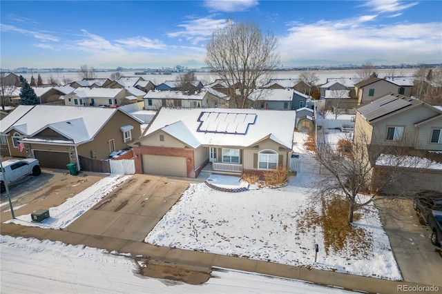 snowy aerial view with a residential view