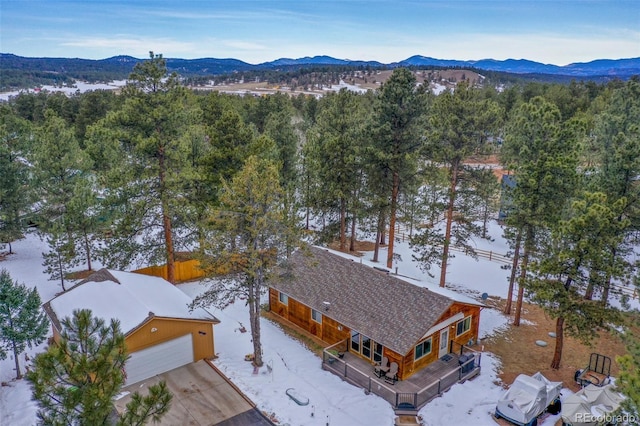 snowy aerial view featuring a mountain view