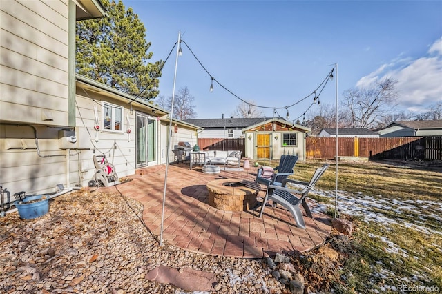 view of yard with an outdoor fire pit, a patio area, and a storage shed