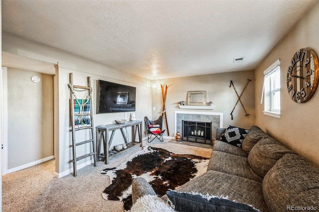 carpeted living room featuring a fireplace and a textured ceiling