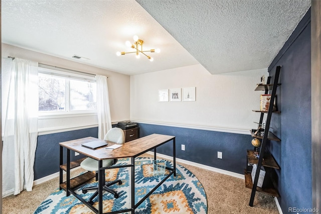 office with an inviting chandelier, light colored carpet, and a textured ceiling