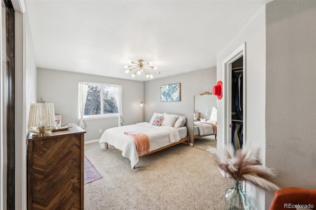 bedroom with a closet, an inviting chandelier, and carpet