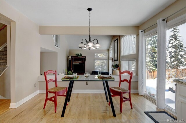 dining room featuring light wood-type flooring and a chandelier