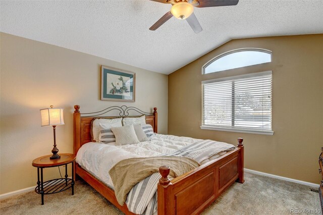 carpeted bedroom with a textured ceiling, lofted ceiling, and ceiling fan