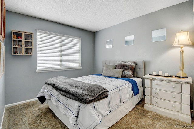 bedroom featuring a textured ceiling and light carpet