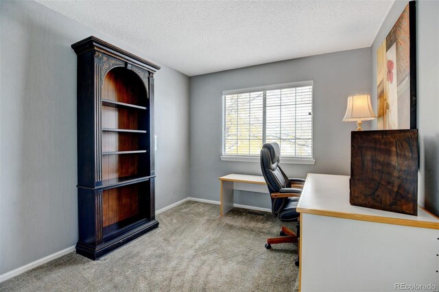 carpeted home office with a textured ceiling