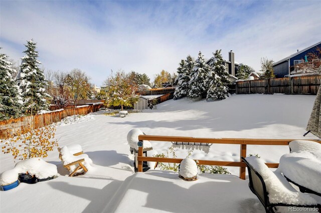 view of yard layered in snow