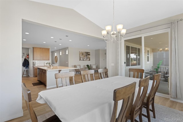 dining area with recessed lighting, a chandelier, vaulted ceiling, and light wood-type flooring