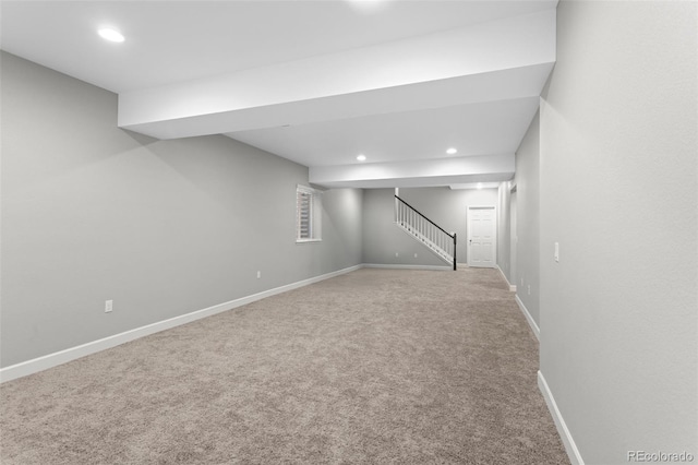 finished below grade area with recessed lighting, baseboards, carpet, and stairs