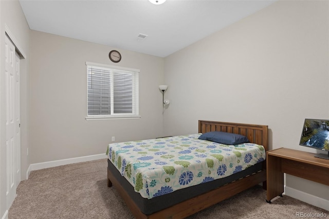 bedroom featuring baseboards, carpet, and a closet