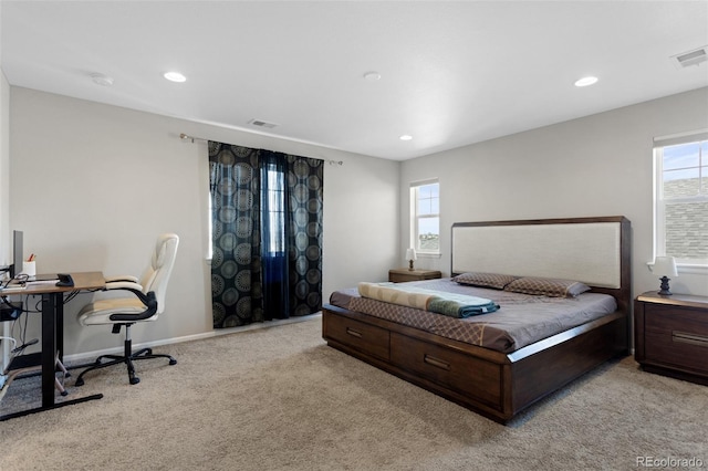 bedroom with visible vents, recessed lighting, and light carpet