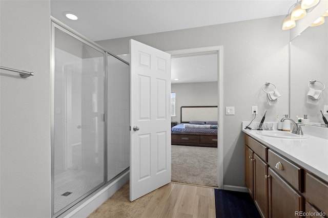 full bath featuring vanity, wood finished floors, recessed lighting, connected bathroom, and a shower stall