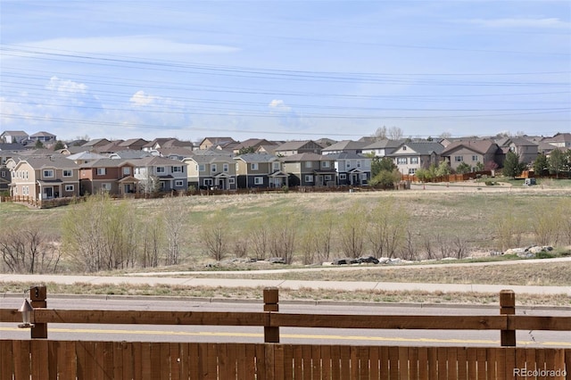 view of yard featuring fence and a residential view