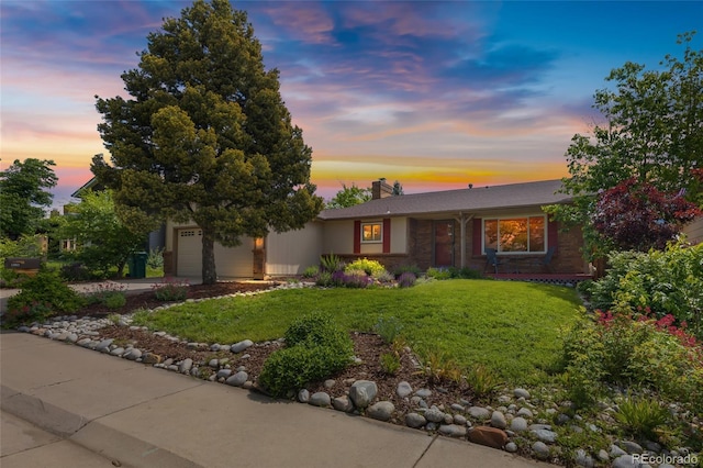 1982 S Truckee St, Aurora, CO 80013 - view of front facade featuring a front lawn, a garage, a chimney, and driveway