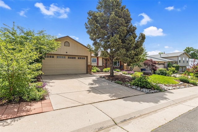 1982 S Truckee St, Aurora, CO 80013 - view of front of home with an attached garage, concrete driveway, and brick siding