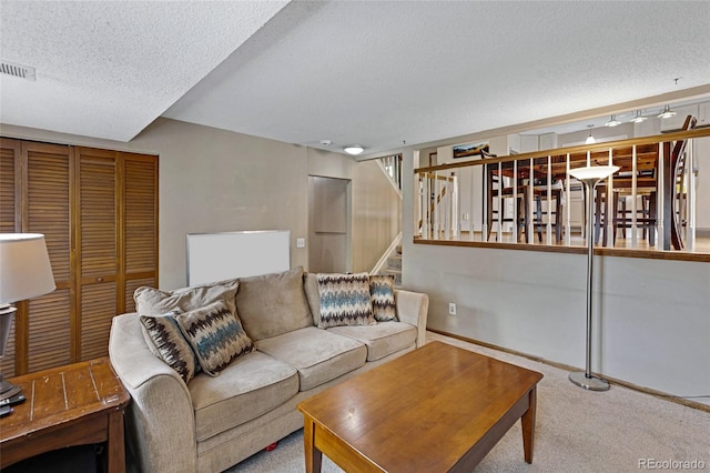 1982 S Truckee St, Aurora, CO 80013 - living area with a textured ceiling, carpet floors, and stairs