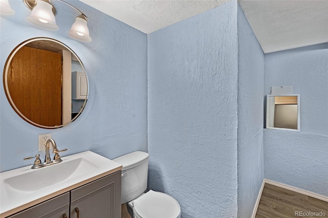 1982 S Truckee St, Aurora, CO 80013 - bathroom with wood finished floors, vanity, a textured wall, and a textured ceiling