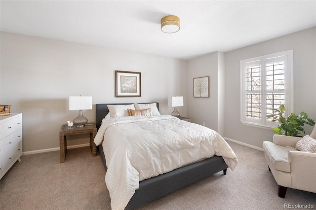 bedroom with baseboards and light colored carpet