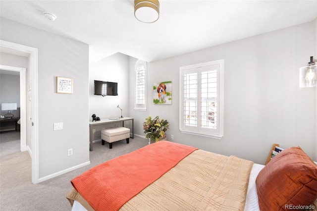 carpeted bedroom featuring baseboards