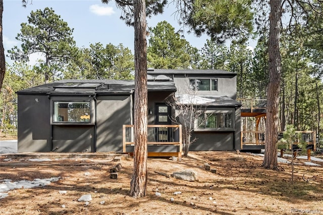 back of property featuring stucco siding