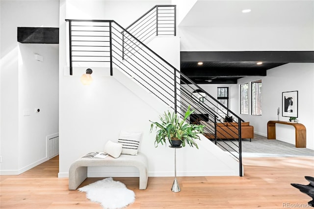 staircase featuring visible vents, baseboards, beamed ceiling, recessed lighting, and wood finished floors