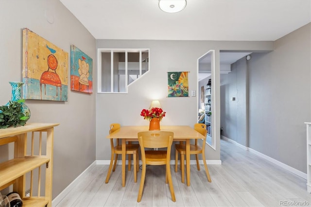 dining room with wood finished floors and baseboards