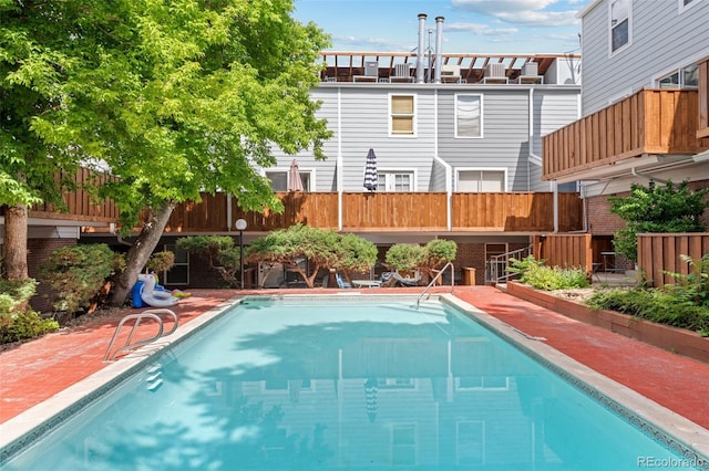 view of swimming pool featuring fence and a fenced in pool