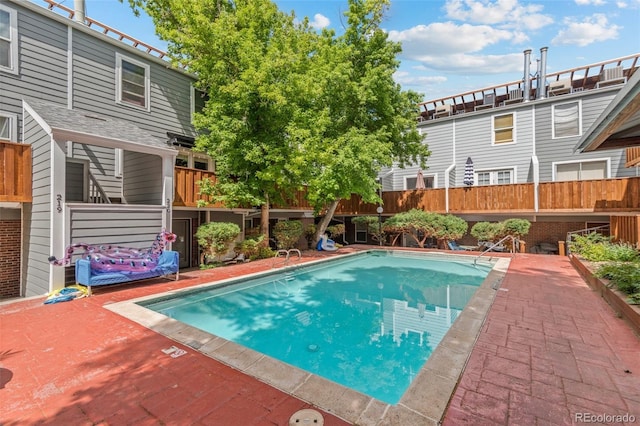 outdoor pool featuring fence