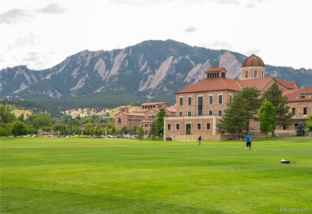 exterior space with a yard and a mountain view