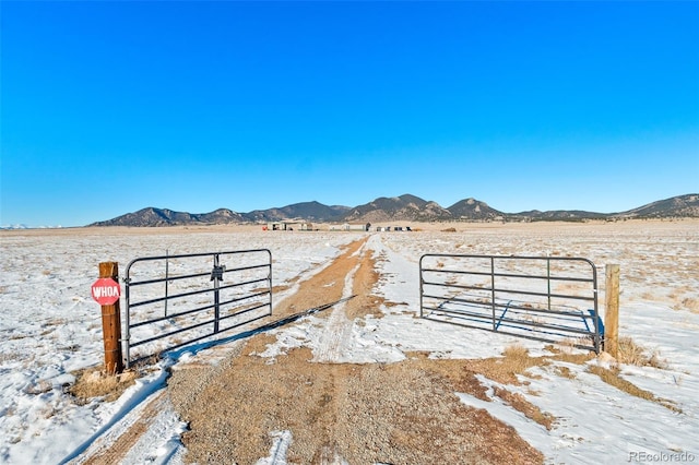 view of gate featuring a mountain view and a rural view