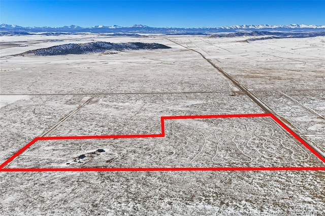 snowy aerial view with a mountain view