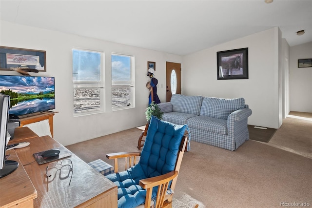 carpeted living room featuring vaulted ceiling