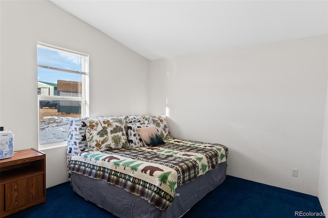 carpeted bedroom with vaulted ceiling