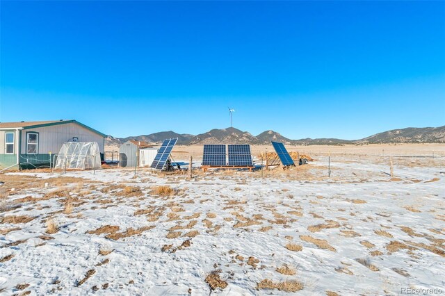 view of front of property featuring a mountain view and ground mounted solar panels