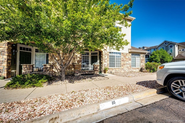 452 Black Feather Loop Unit 608, Castle Rock, CO 80104 - obstructed view of property with stone siding and a porch
