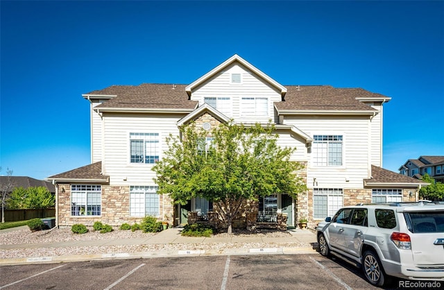 452 Black Feather Loop Unit 608, Castle Rock, CO 80104 - townhome / multi-family property featuring stone siding, uncovered parking, and a shingled roof