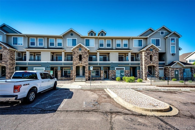 452 Black Feather Loop Unit 608, Castle Rock, CO 80104 - townhome / multi-family property featuring stone siding and uncovered parking