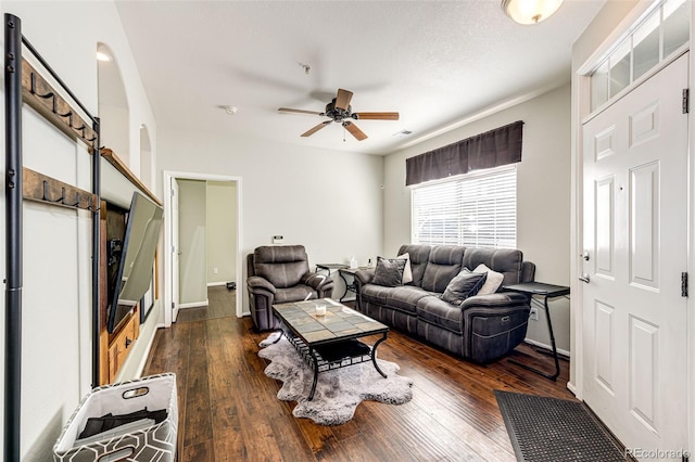 452 Black Feather Loop Unit 608, Castle Rock, CO 80104 - living room featuring a ceiling fan, dark wood-type flooring, and baseboards