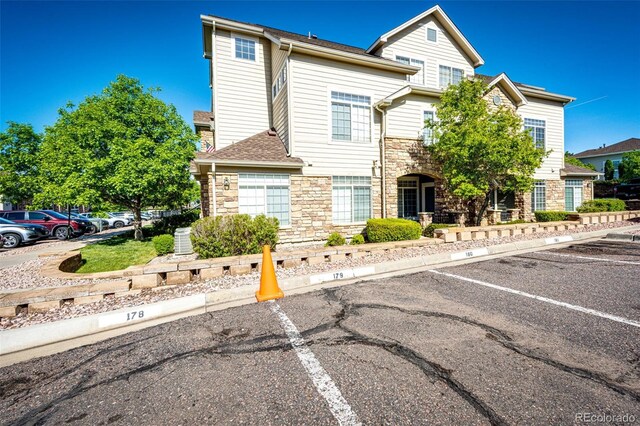 452 Black Feather Loop Unit 608, Castle Rock, CO 80104 - view of front of home with stone siding and uncovered parking