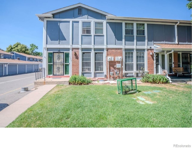 rear view of house featuring a yard