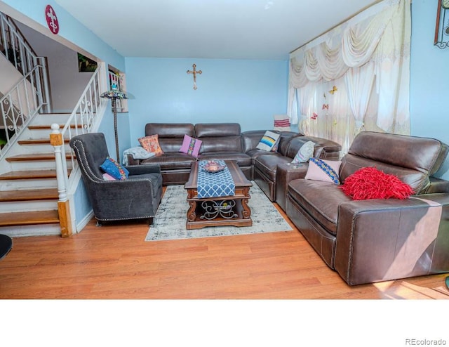 living area featuring stairs and wood finished floors