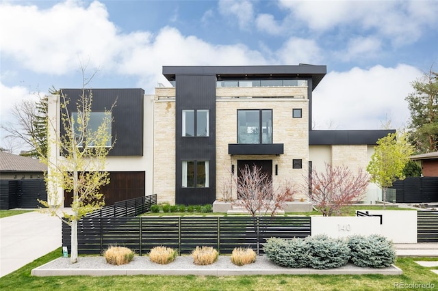 140 S Glencoe St, Denver, CO 80246 - modern home featuring a fenced front yard, a garage, and driveway