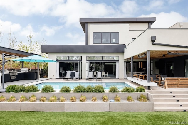 140 S Glencoe St, Denver, CO 80246 - back of property featuring an outdoor pool, exterior kitchen, and stucco siding