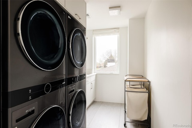 140 S Glencoe St, Denver, CO 80246 - laundry area with estacked washer and dryer and cabinet space