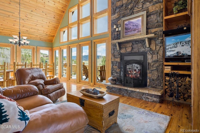 62 897, Grand Lake, CO 80447 - living area featuring hardwood / wood-style flooring, a chandelier, wooden ceiling, high vaulted ceiling, and a stone fireplace