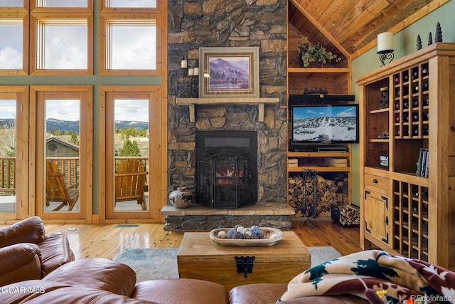 62 897, Grand Lake, CO 80447 - living area with lofted ceiling, wood ceiling, wood-type flooring, and a stone fireplace