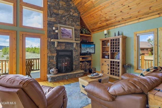 62 897, Grand Lake, CO 80447 - living area with lofted ceiling, hardwood / wood-style floors, a stone fireplace, and wooden ceiling