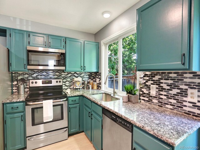 453 Arden Cir, Highlands Ranch, CO 80126 - kitchen featuring stainless steel appliances, tasteful backsplash, and light stone countertops